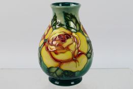 Moorcroft - A Moorcroft Pottery vase decorated in the Rose pattern, impressed marks to the base,