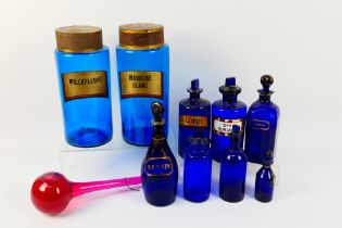 A collection of blue glass apothecary and similar jars,