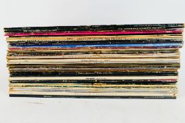 A collection of 12" vinyl records to include Meat Loaf, Cher, ABBA, Blondie,