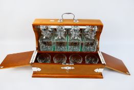 A good quality tantalus with chromed mounts, four matching cut crystal decanters and four tumblers,