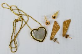 A yellow metal and mother of pearl heart shaped pendant on 9ct yellow gold box link chain (40 cm