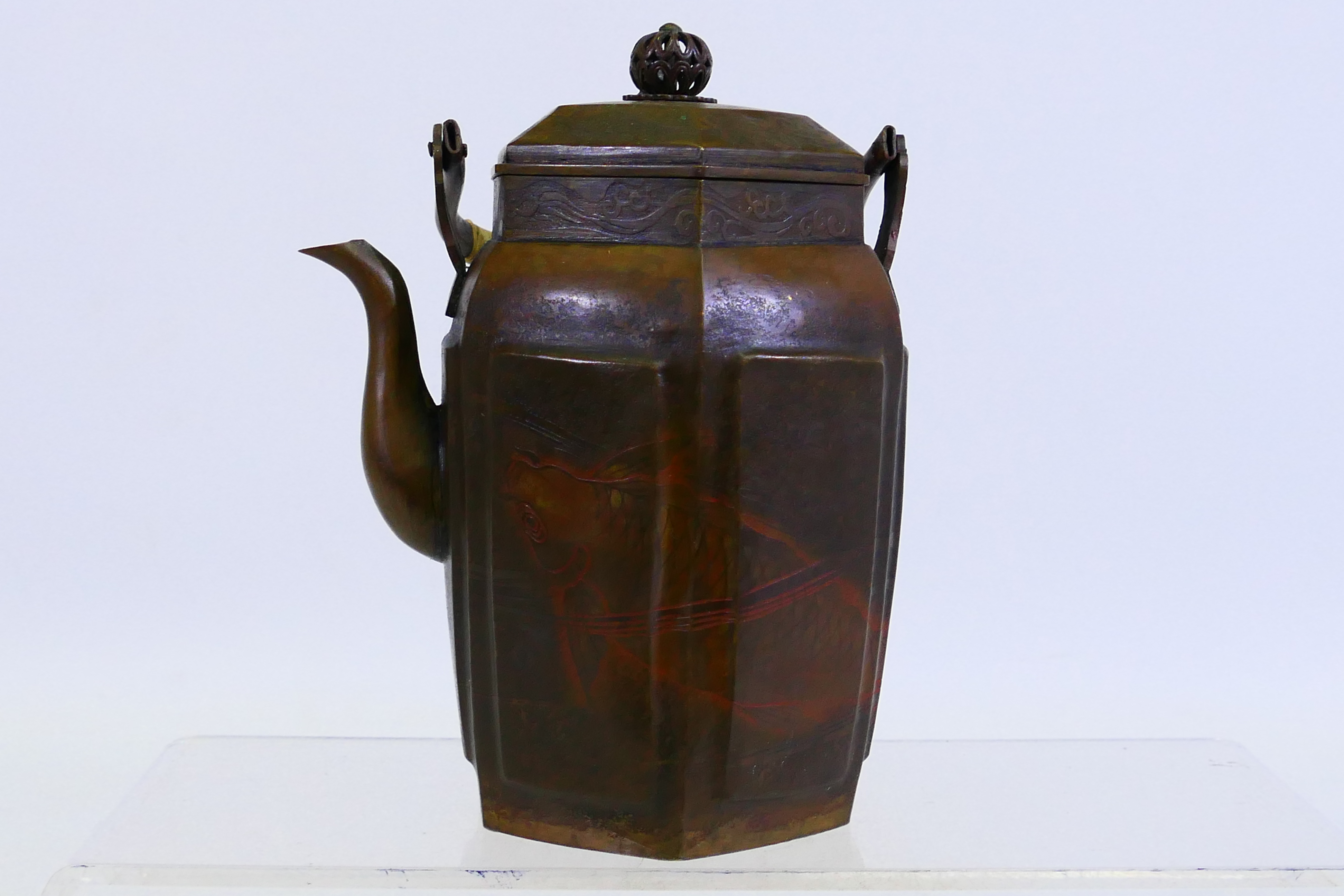 A hexagonal section metal teapot and cover with cane wrapped handle, 16 cm (h).