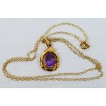 A 9ct yellow gold and amethyst pendant on fine trace 42 cm (l) chain (chain stamped 9k),