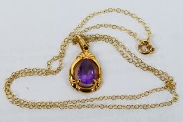 A 9ct yellow gold and amethyst pendant on fine trace 42 cm (l) chain (chain stamped 9k),