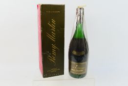 A 24 fl ozs bottle of Remy Martin Grande Reserve Cognac, 70° Proof, the bottle numbered 49907,