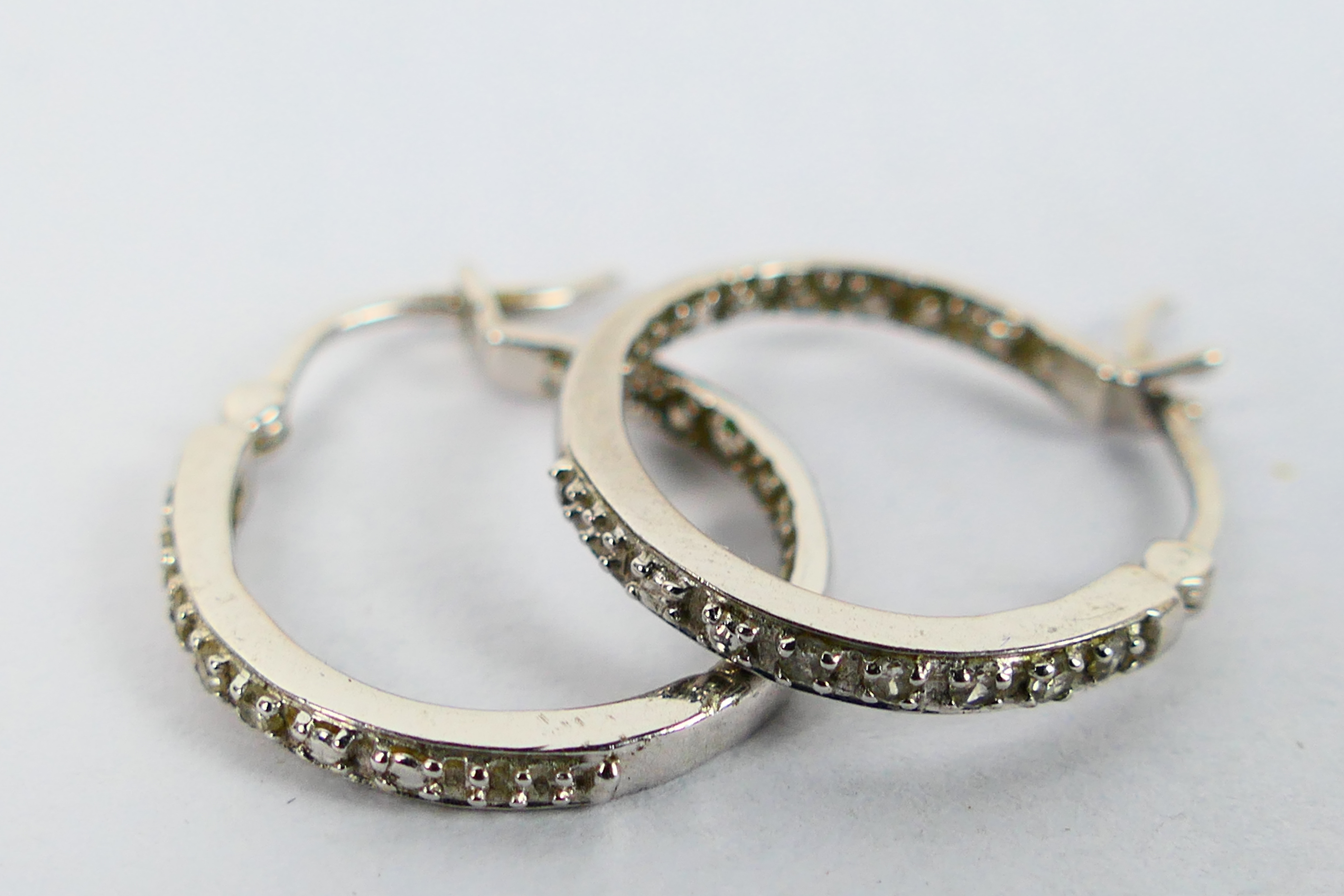 A pair of 9ct white gold, stone set ear hoops, approximately 2.7 grams. - Image 2 of 3
