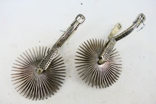 A pair of South American, white metal, rowel spurs with 13 cm (d) rowels.