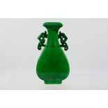 A small Chinese green glaze, twin handled vase, incised decoration depicting a Qilin,