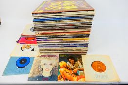 A collection of 12" and 7" vinyl records to include Michael Jackson, The Beach Boys, Fleetwood Mac,