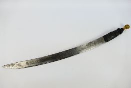 An African Manding type sword with 55 cm (l) curved blade and compressed spherical brass pommel,