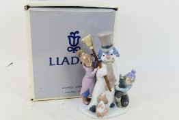 Lladro - A boxed figure group entitled The Snow Man, # 5713, depicting children building a snowman,