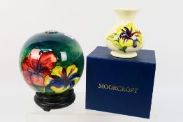 Moorcroft - A small Moorcroft Pottery vase decorated in the Hibiscus pattern reserved against a