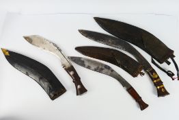 Three vintage Kukri, each with scabbards, one marked to the blade with broad arrow,