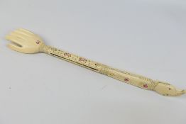 A bone back scratcher in the form of a hand,