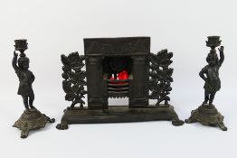 A pair of cast iron figural candlesticks by E G Zimmermann, Hanau,