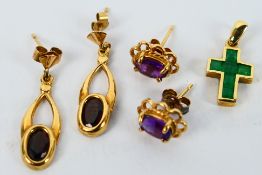 A yellow metal and emerald crucifix pendant, stamped 375 and two pairs of yellow metal earrings,