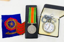 A World War Two (WW2 / WWII) Defence Medal, cloth patches and a military pocket watch,