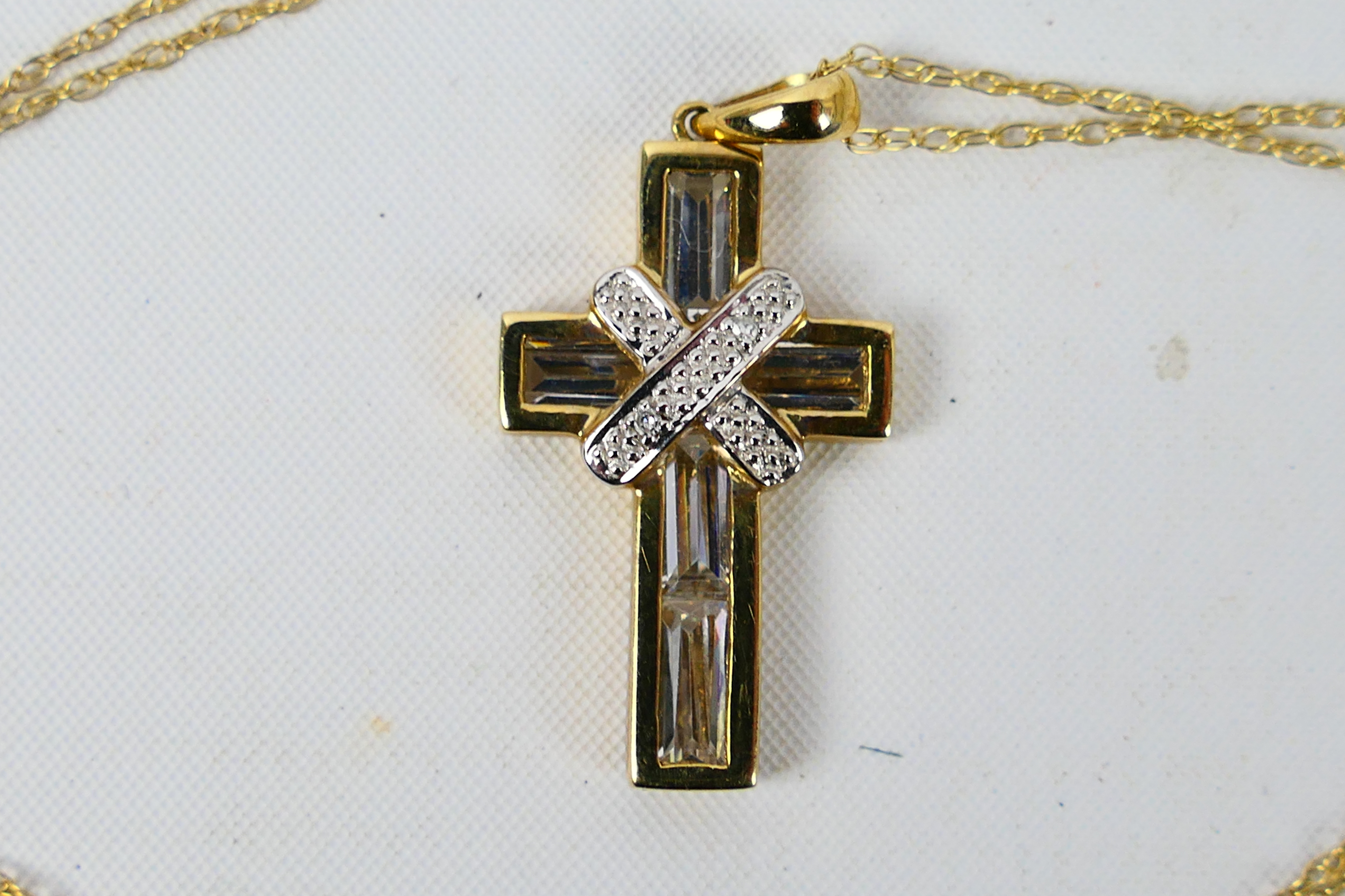 A 9ct yellow gold, stone set crucifix pendant on yellow metal chain stamped 375, approximately 3. - Image 2 of 3