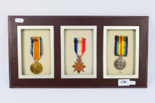 A display of three World War One (WW1 / WWI) medals comprising 1914 - 1915 Star,