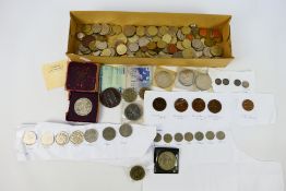 A collection of UK and foreign coins including a small quantity with silver content also includes a