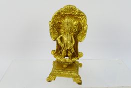 A small gilt metal figure on stand in the form of a Napoleonic style military figure urinating into