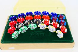 A set of vintage Sugar Puffs football pencil toppers, 27 in total, with display stand and cover.