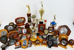 A large quantity of vintage sporting trophies.