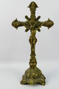 A brass crucifix. 48 cm (h). Appears in good condition, although, has some dust.