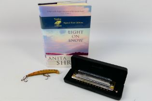 A Hohner Super Chromonica harmonica (cas