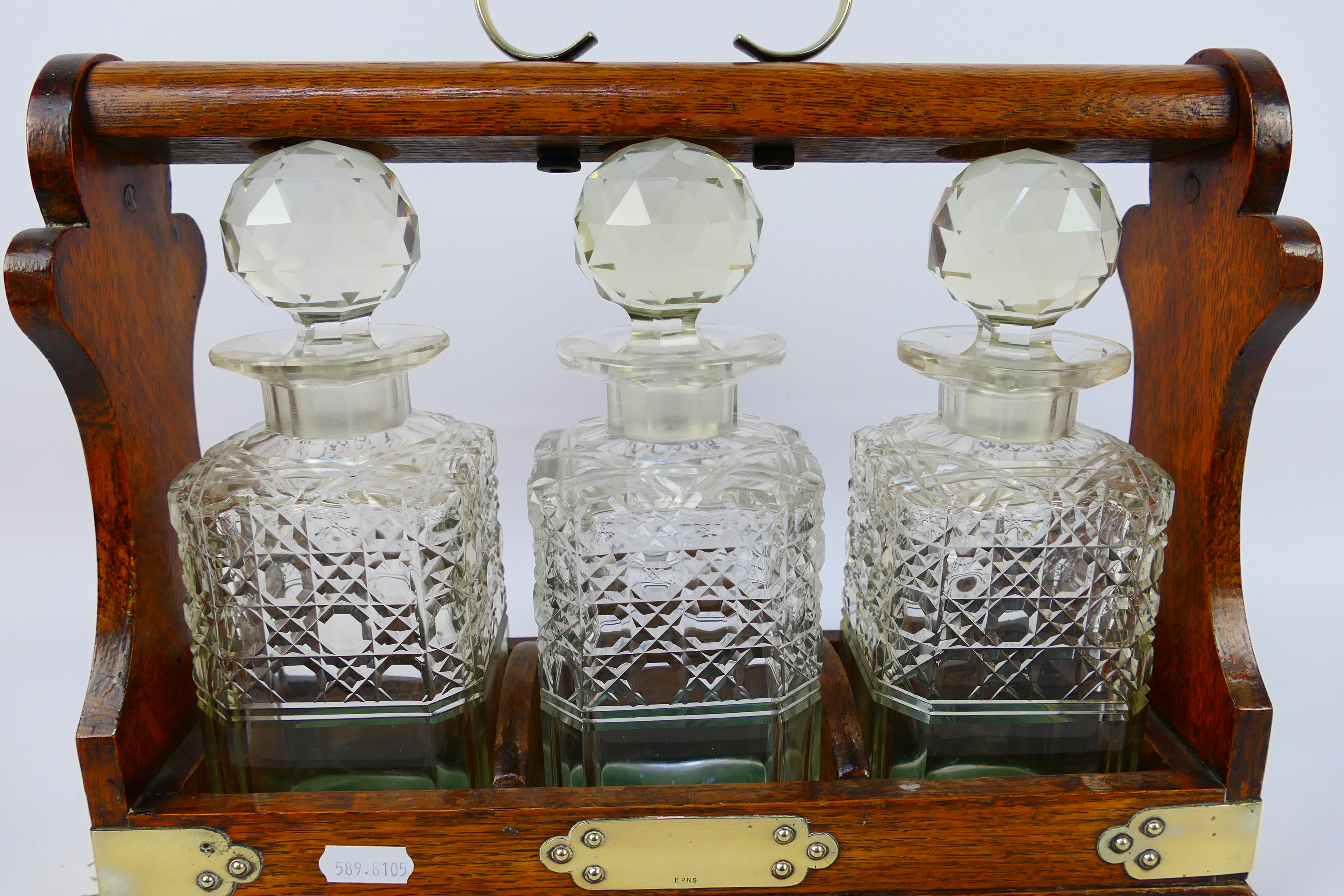 A three decanter oak tantalus with plated mounts, no maker's mark visible. - Image 2 of 6