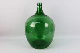 A large green glass carboy, approximatel