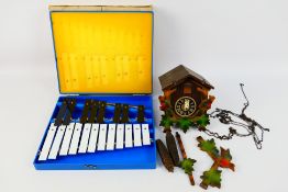 A German cuckoo clock with pendulum and weights and a glockenspiel. [2].