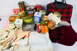 A quantity of vintage linen, knitting patterns, confectionary and similar tins. [2].