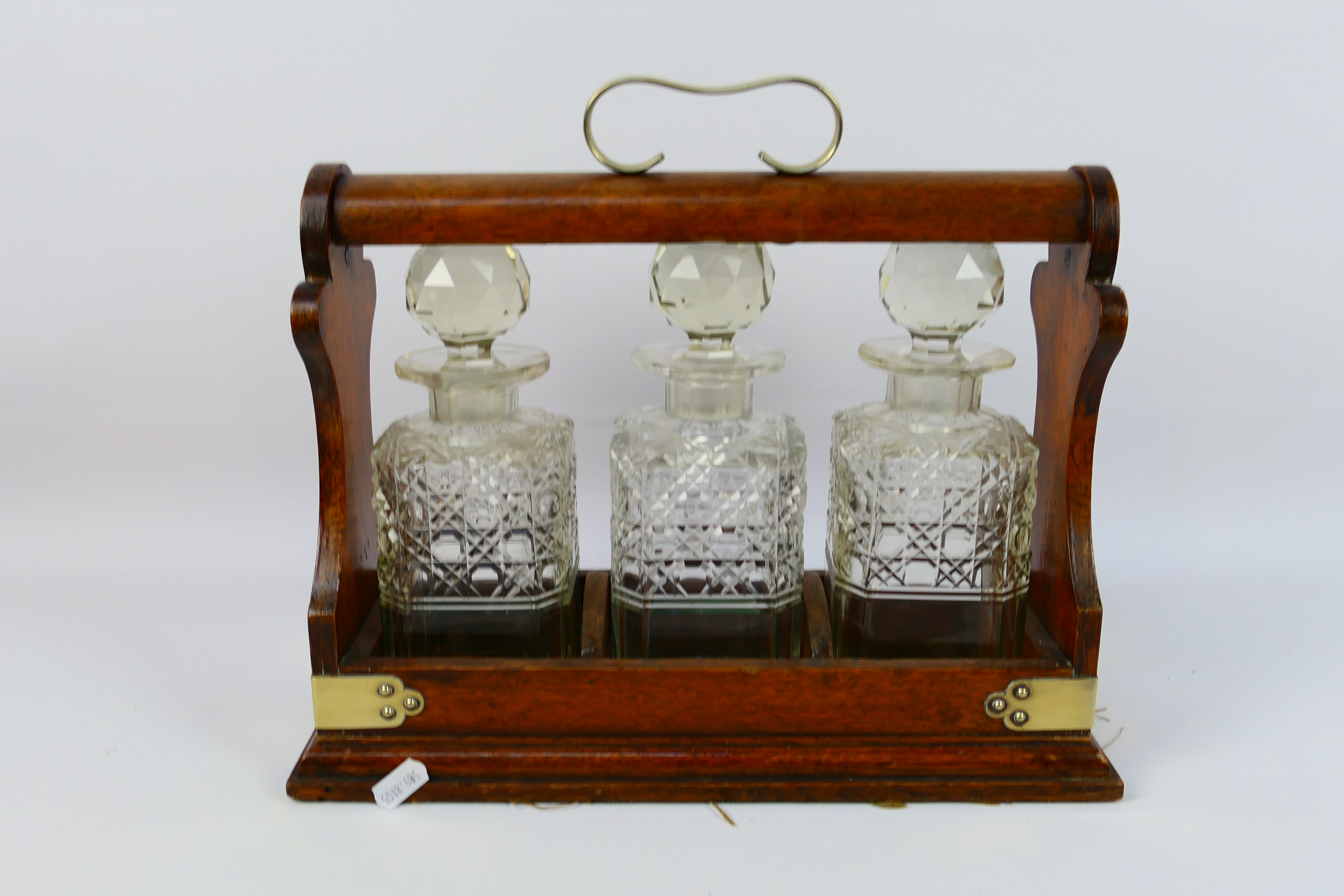 A three decanter oak tantalus with plated mounts, no maker's mark visible. - Image 5 of 6