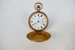 A gold plated full hunter pocket watch, Roman numerals to a white enamel dial,