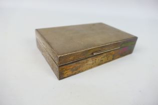 A silver cigarette box with engine turned decoration, Sheffield assay 1958,
