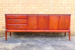A Beithcraft Ltd sideboard having an arrangement of cupboards and three drawers,