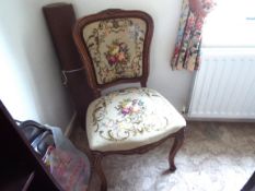 An early 20th century bedroom chair with floral upholstery to the back and seat,