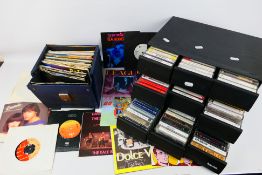 A collection of vintage 7" vinyl records and audio cassettes to include The Beatles, Blondie,