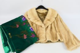 A lady's short fur jacket, 47 cm (l) from collar to hem, and Japanese floral decorated textile.