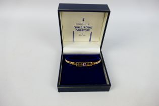 A 9ct yellow gold bangle, Reflections Of Charles Rennie Mackintosh by Solar, 6.5 cm wide, 5.
