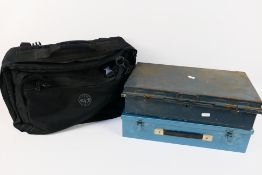 Two vintage metal tins, a German straight razor and a travel bag.