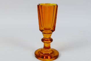 A Toastmaster's firing glass, the amber