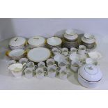 A collection of white glazed dinner and tea wares with gilt highlights to include Thomas,