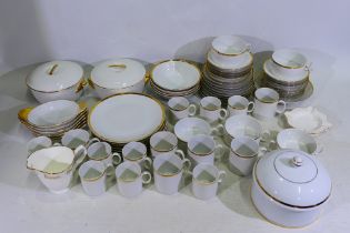 A collection of white glazed dinner and tea wares with gilt highlights to include Thomas,