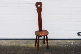 A wooden spinning chair with heart-shaped design. 120 cm (h) x 31 cm (d) x 35 1/2 cm (w).