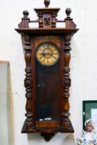 A Vienna-style wall clock. 124 cm (h) x 43 cm (w) x 20 cm (d).
