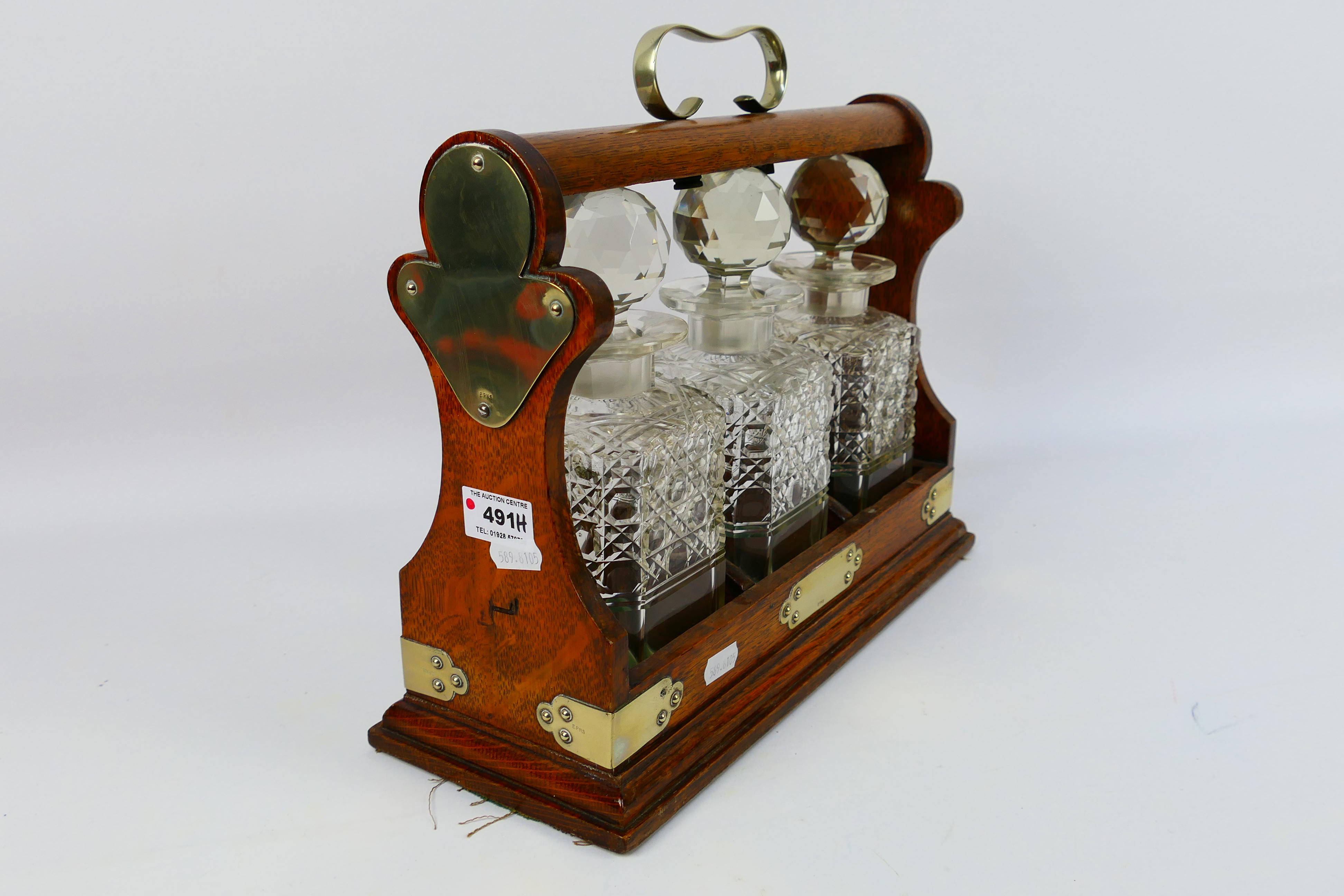 A three decanter oak tantalus with plated mounts, no maker's mark visible. - Image 4 of 6