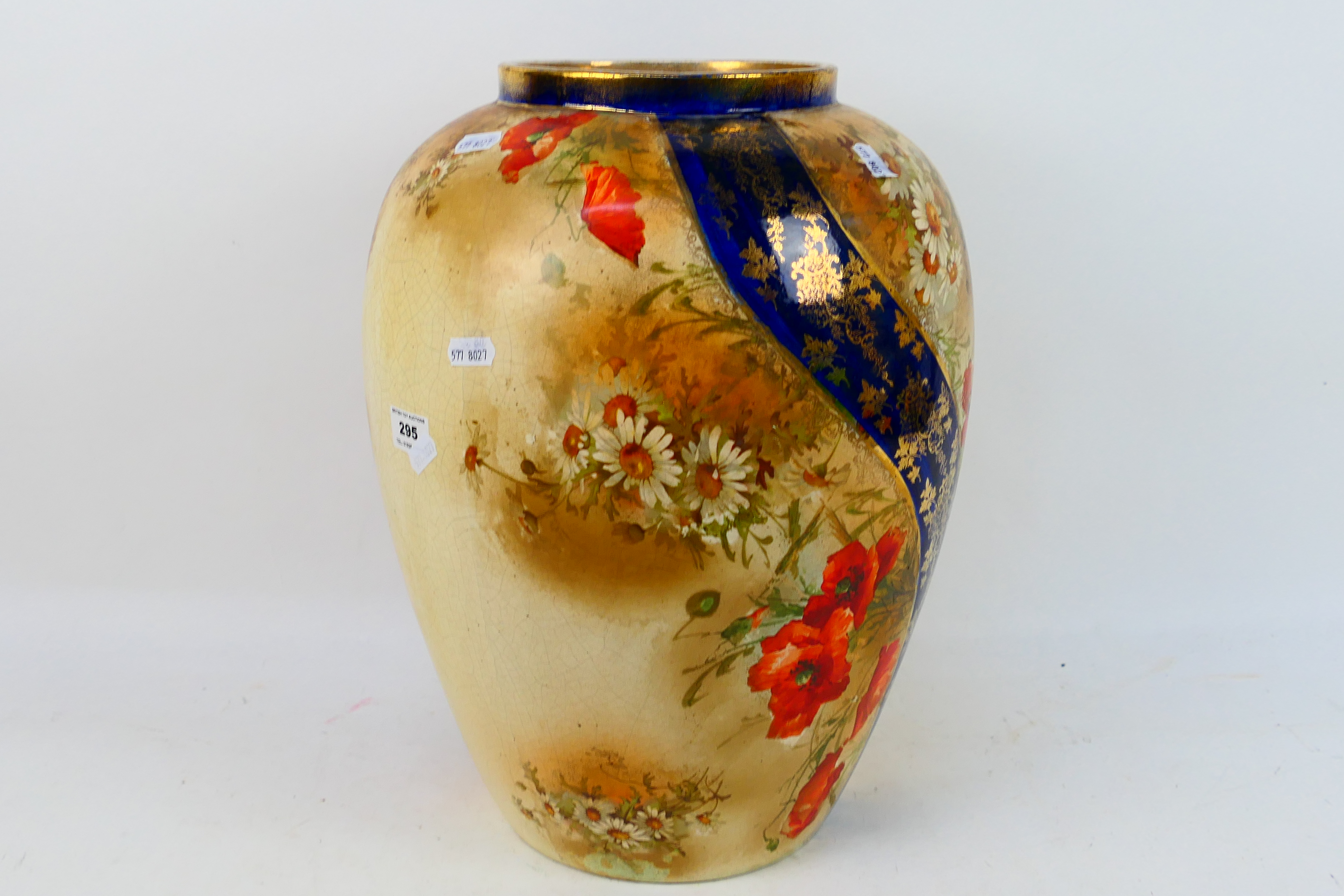 A large vase with floral and gilt decora