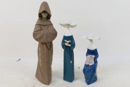 Lladro - Three figures comprising a monk